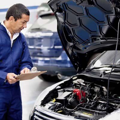 Man inspecting car - Walt's Auto Service Center, Taunton, MA Man inspecting car - Walt's Auto Service Center, Taunton, MA