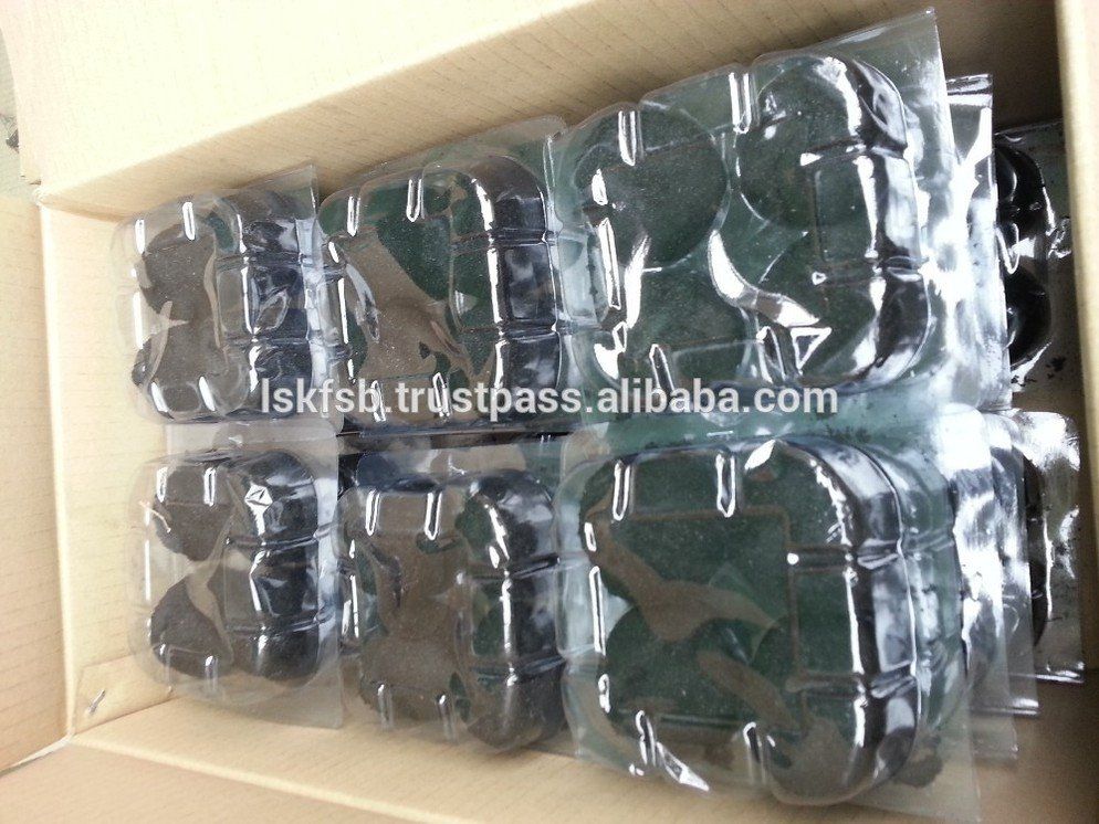 Cardboard box filled with clear-wrapped packages of dark, round objects.