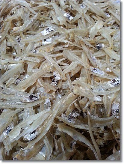 Pile of dried, small, silvery fish.