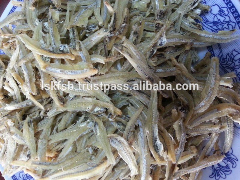 Dried anchovies in a white and blue patterned dish, close-up shot.