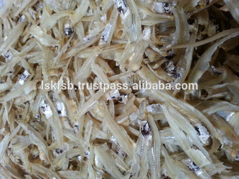 Pile of dried, small, silvery fish with dark eyes and visible bones.