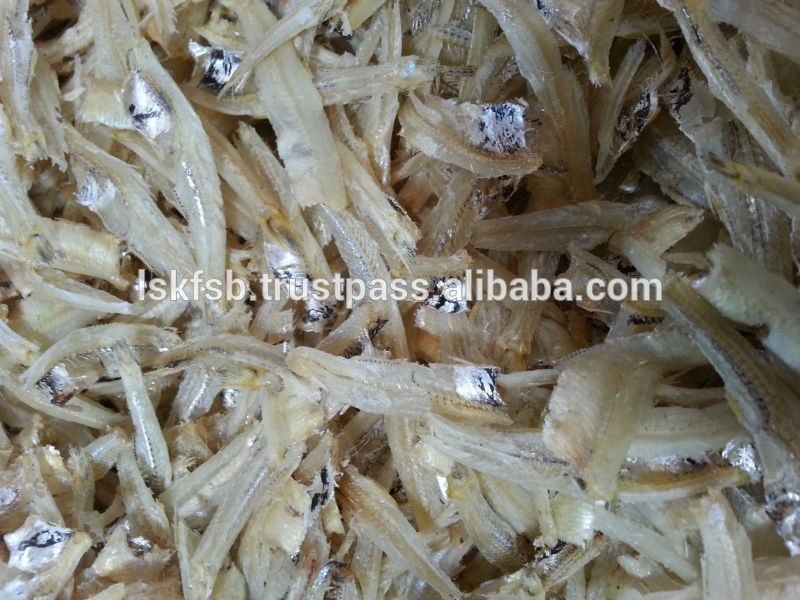 Dried small fish, light beige color, close up.
