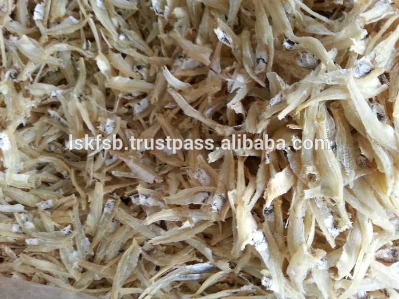 Dried, silvery-white anchovies, packed closely together, likely for sale.