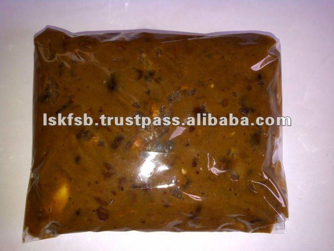 A sealed plastic bag containing a brown, pulpy food product; likely a paste or sauce.