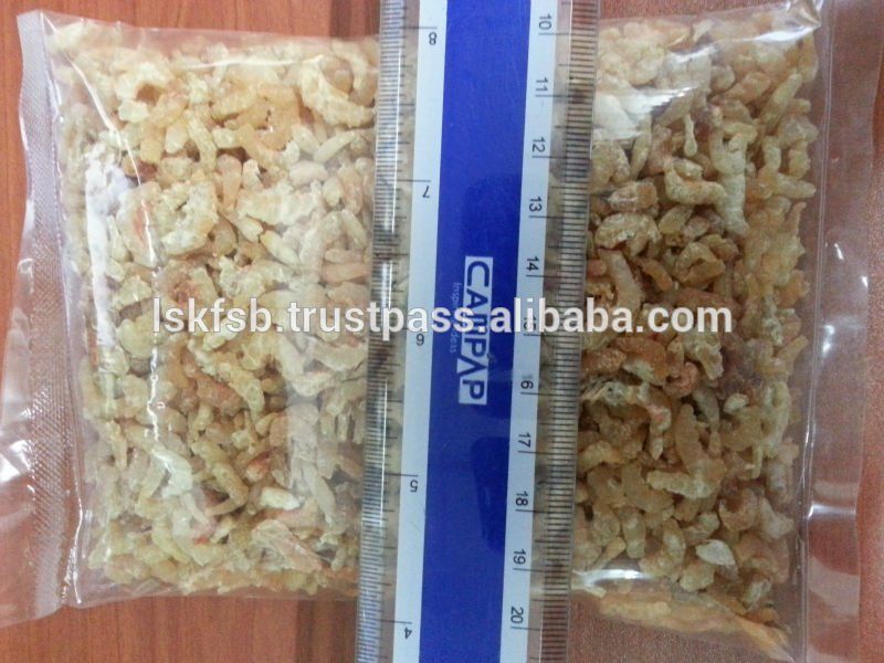Two bags of dried shrimp next to a ruler, possibly for size comparison.