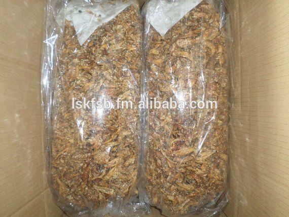 Two plastic-wrapped bags filled with brown shredded material inside a cardboard box.