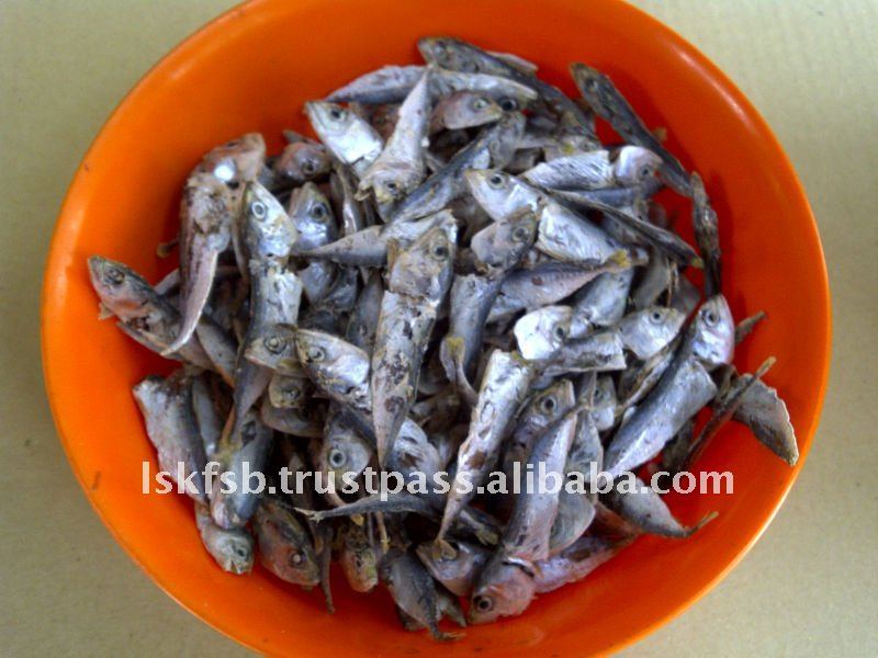 Dried, small fish in an orange bowl.