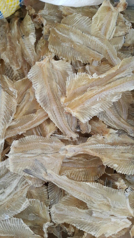Dried fish, light brown, stacked close together.