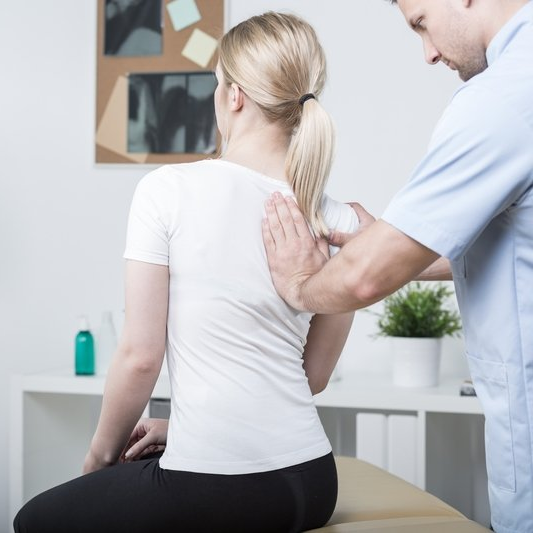 A man is giving a woman a massage on her back