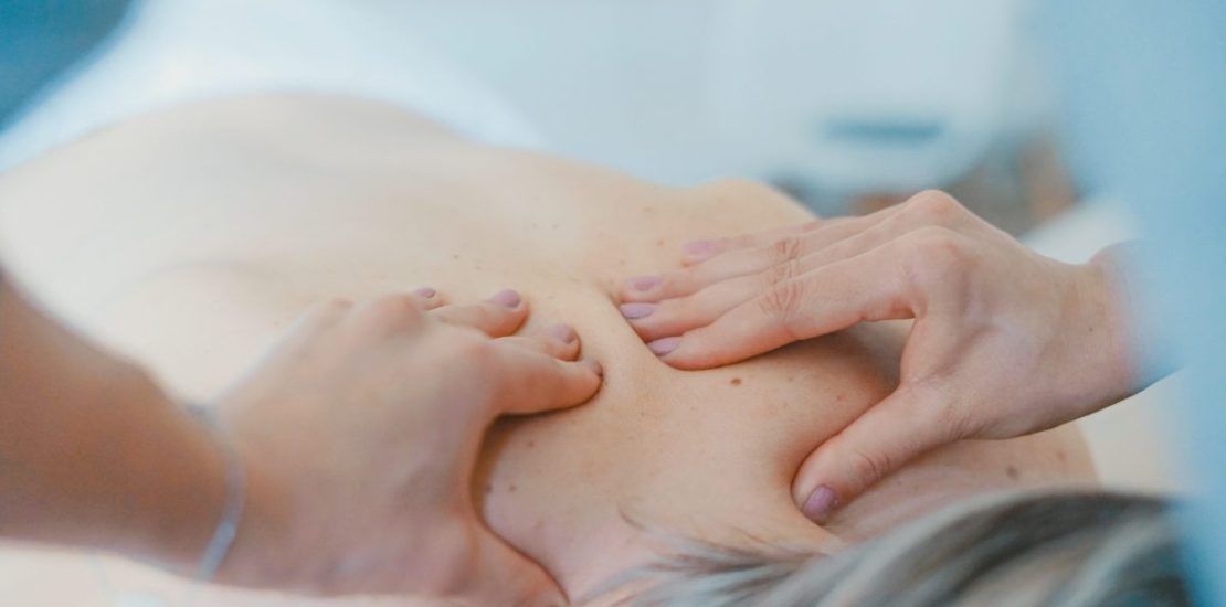 A woman is getting a massage on her back in a spa.