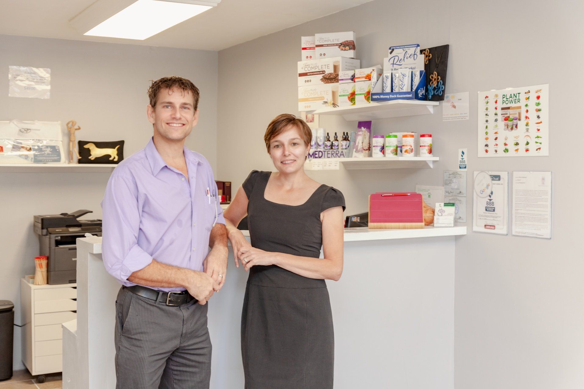 A man and a woman are standing next to each other in a room.