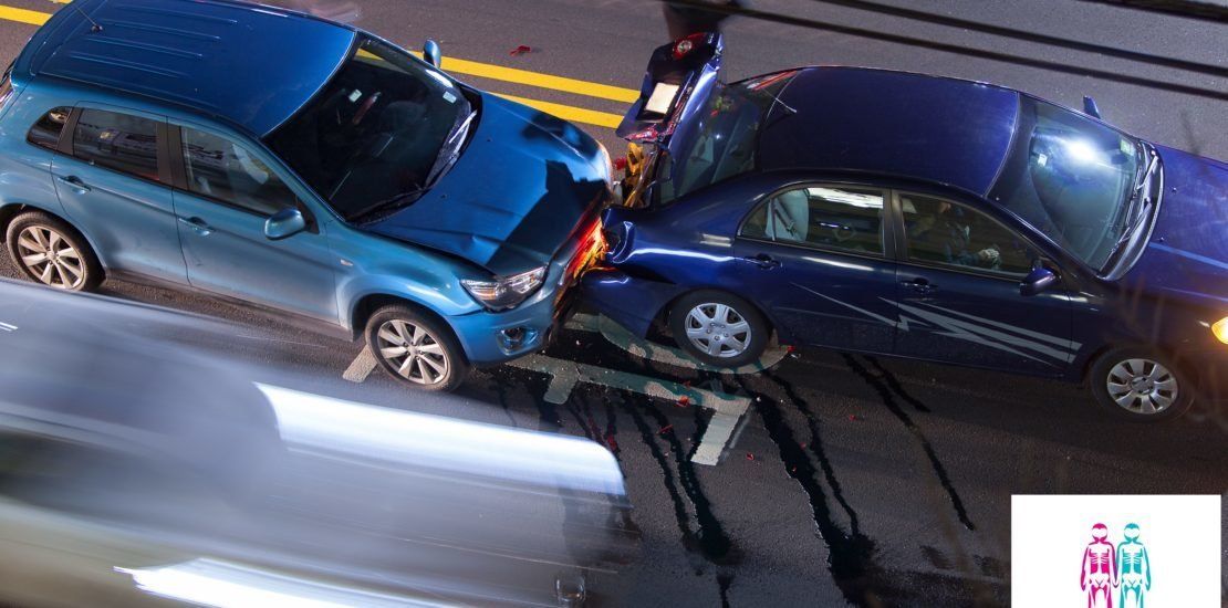 Two blue cars are crashed into each other on a street.