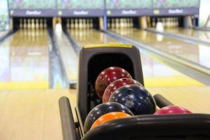 A bowling alley with bowling balls in a bowling alley
