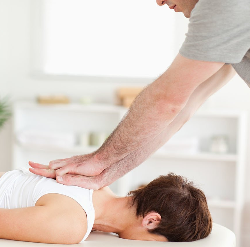 A man is giving a woman a massage on a table