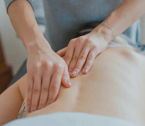 A person is getting a massage on their back.
