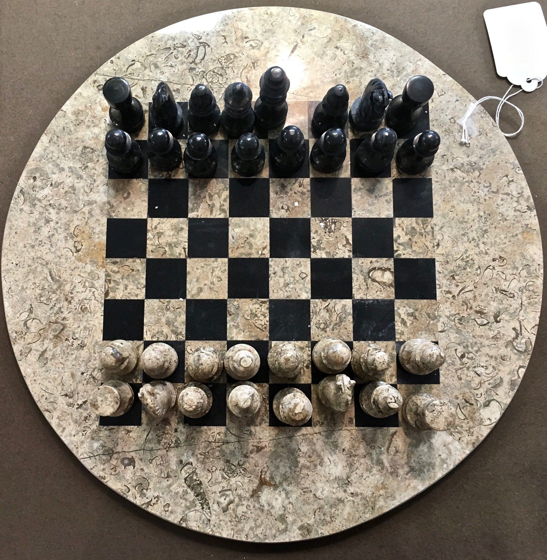 Checkers board with black pieces at top and white pieces at bottom, arranged for a game