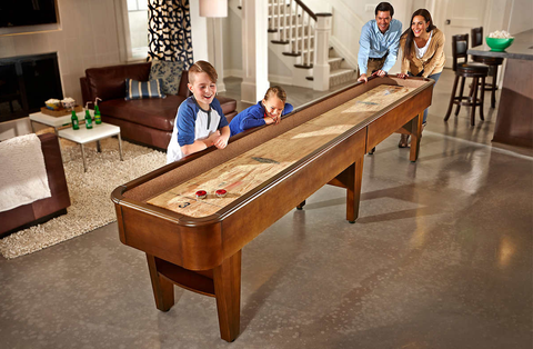 family playing shuffleboard family playing shuffleboard