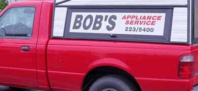 Bob's Service — Appliance Repair in Collins, CO Red Bob’s Appliance Service truck with phone number 223-5400 on the side.