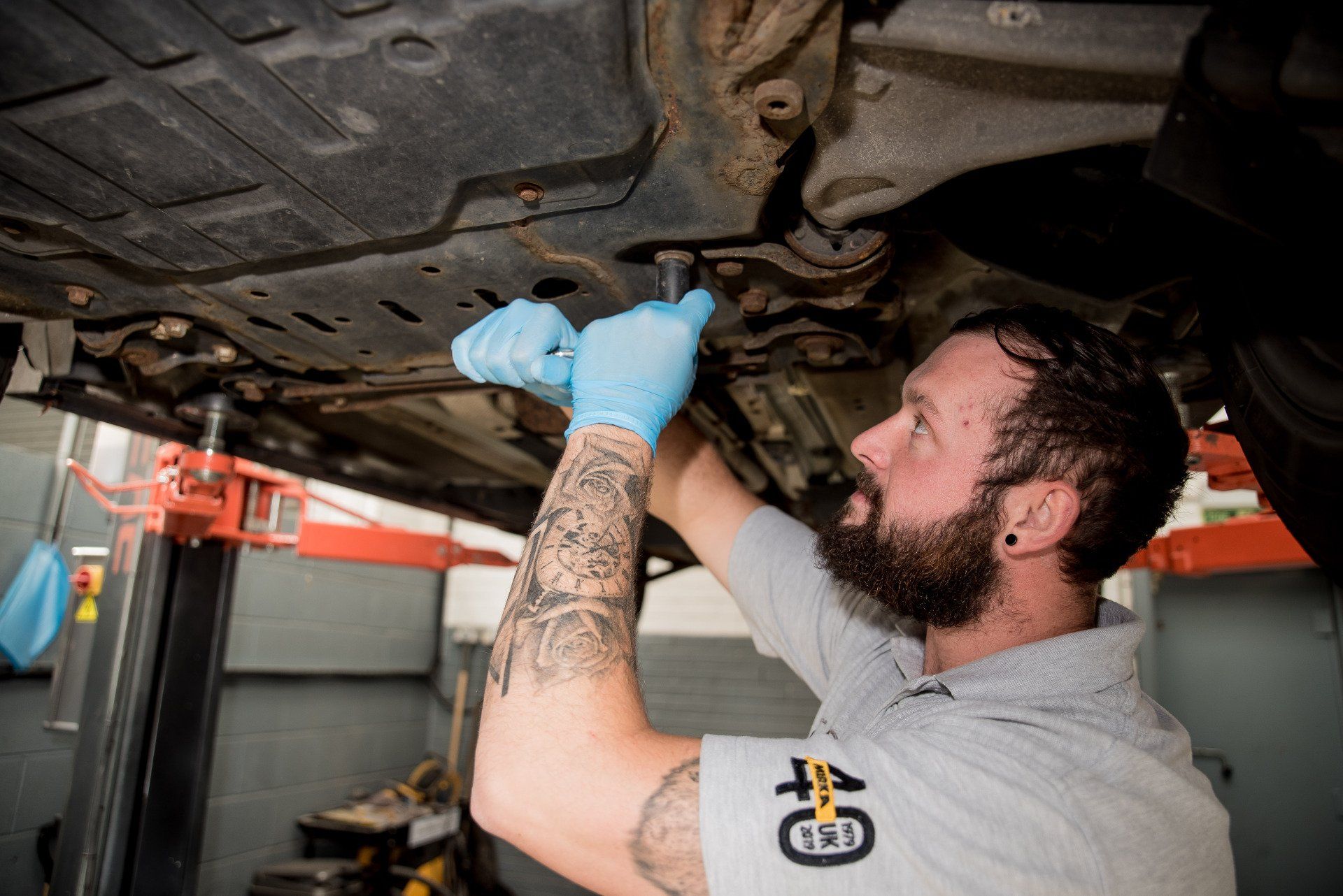 Technician working underneath a vehicle.
