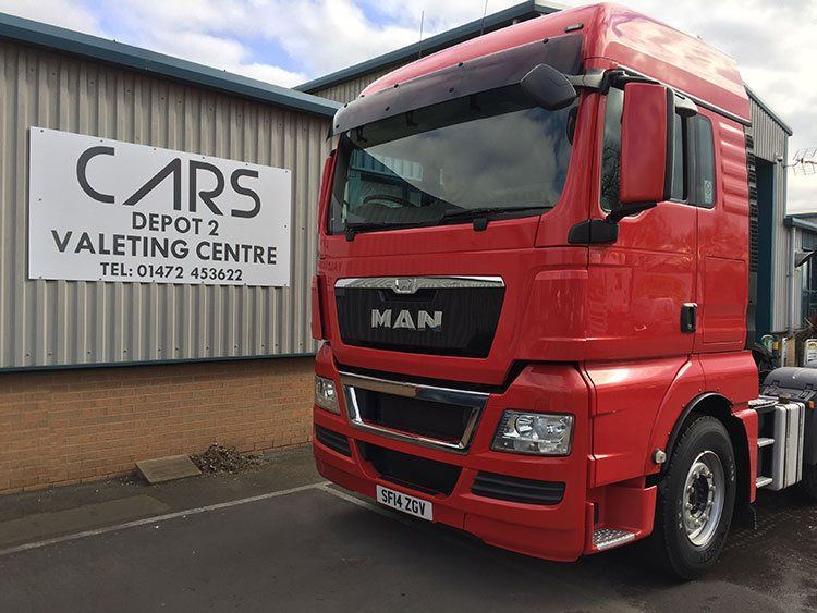 Red MAN HGV looking brand new after a service.