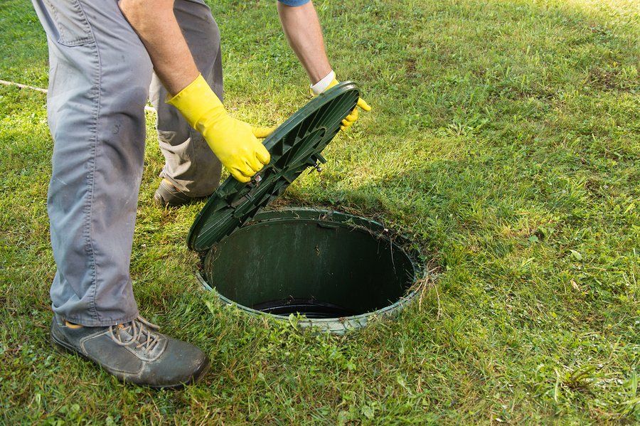 man opens the septic tank