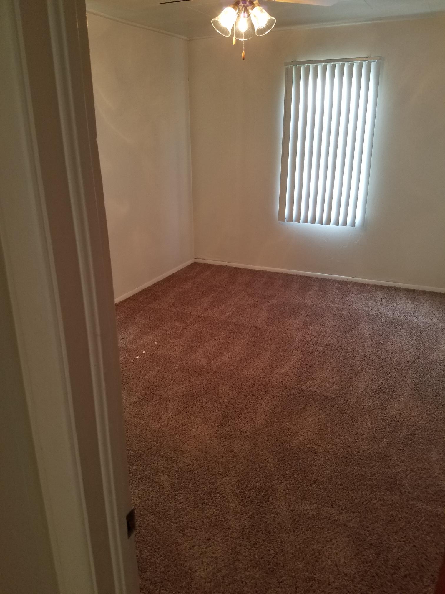 Interior of bedroom with window and light fixture