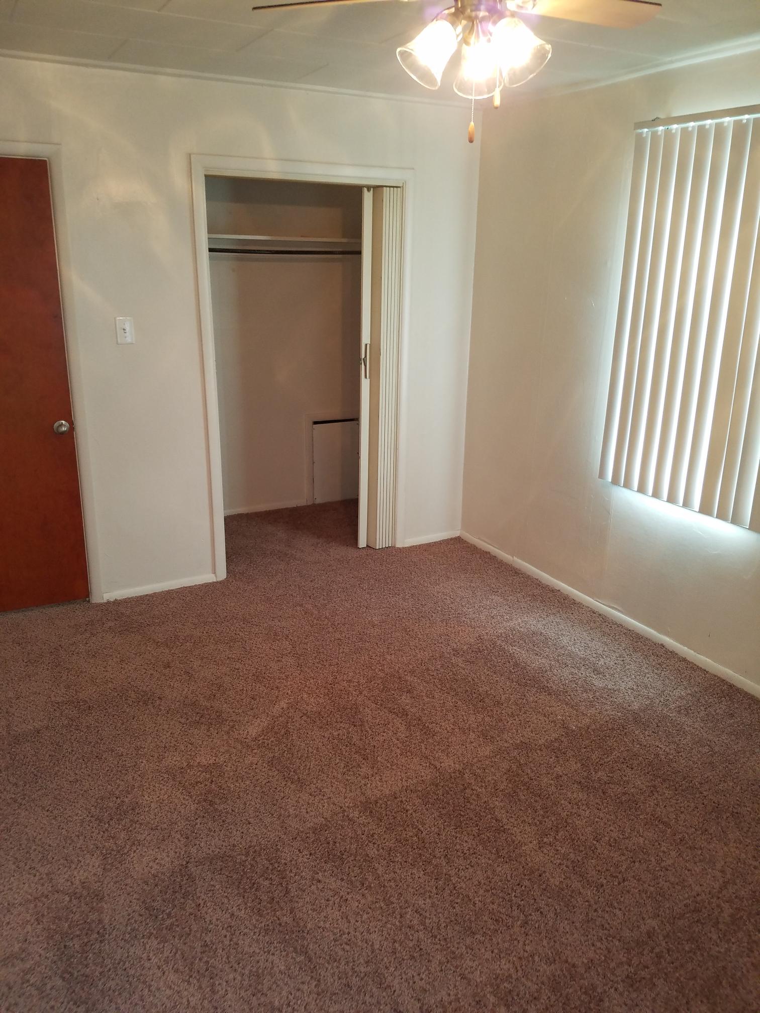 Alternate interior of bedroom with window and light fixture