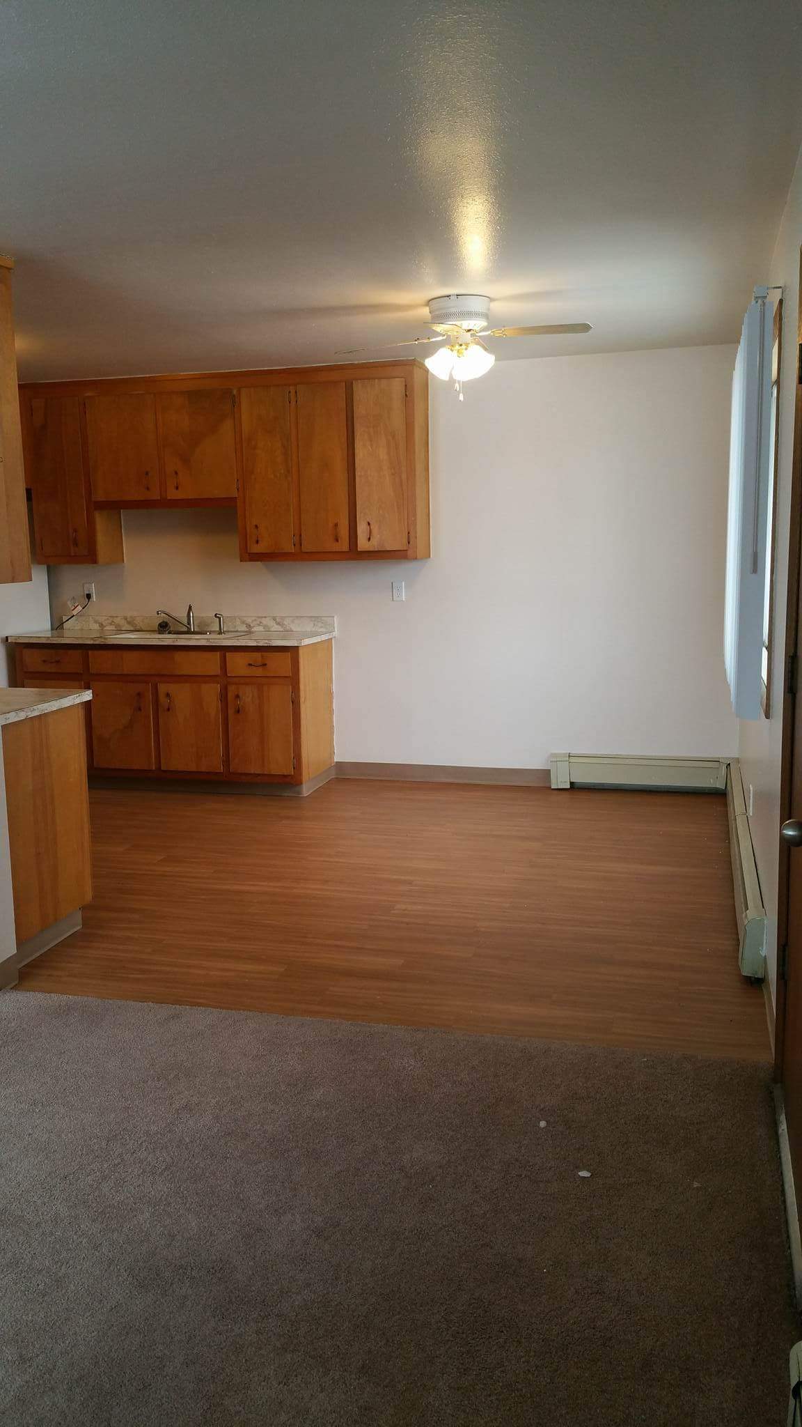 Interior of kitchen and dining area with large window adjacent