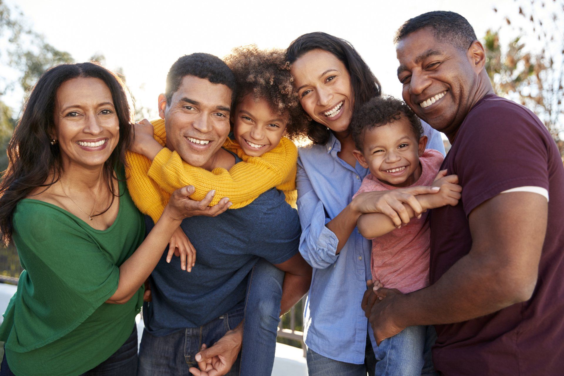 group of men, women, and children smiling together