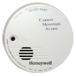 White Honeywell carbon monoxide alarm with a red light and speaker.