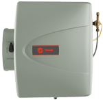 Gray Trane humidifier attached to a wall, with a dial on the left and brass valve on the right.