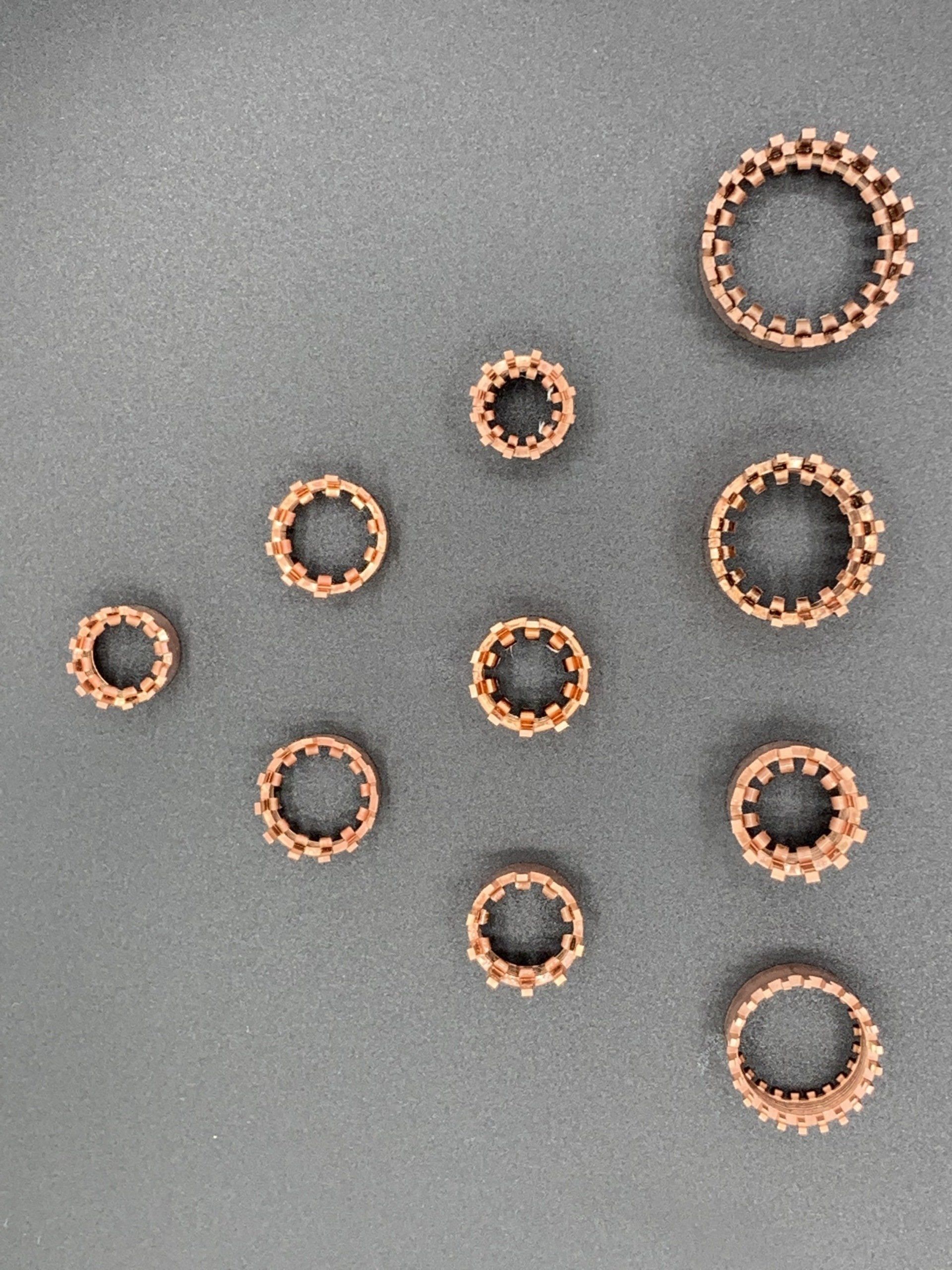 A bunch of rings are lined up on a table