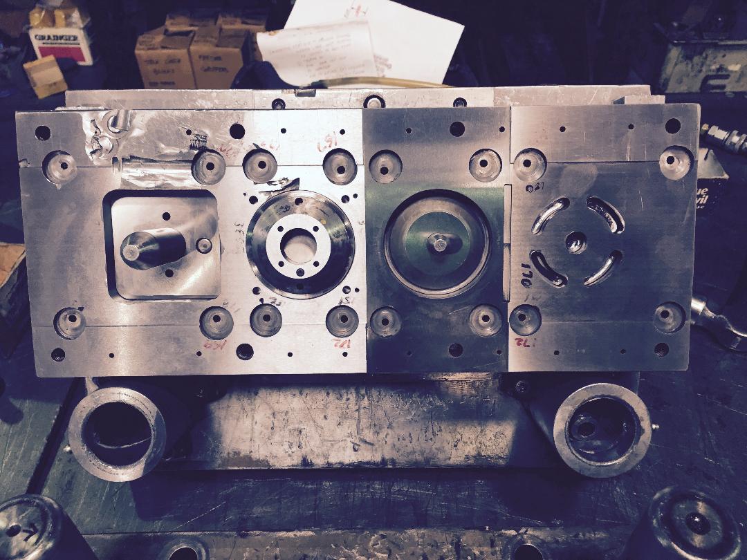 A piece of metal with holes in it is sitting on a table