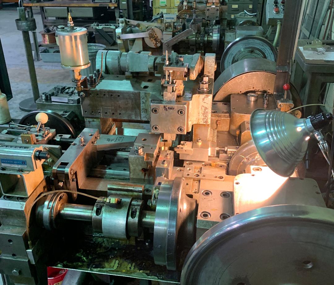 A machine is being used in a factory with a lamp on it