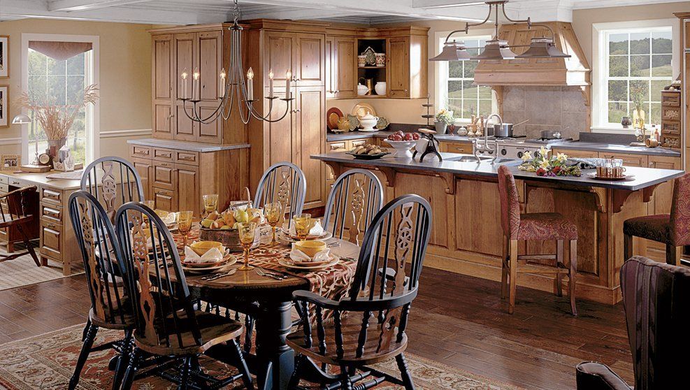 A kitchen with a table and chairs in it