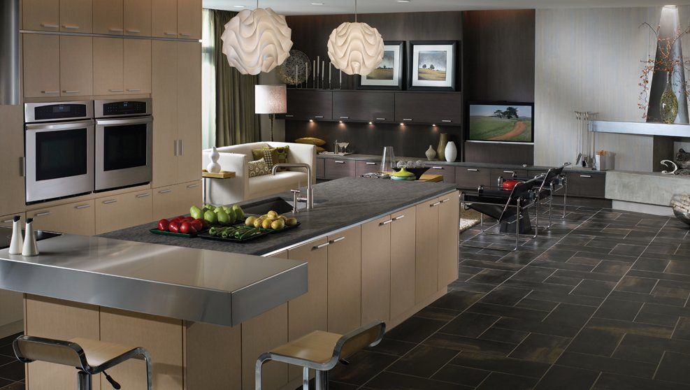A kitchen with a large island and stainless steel appliances
