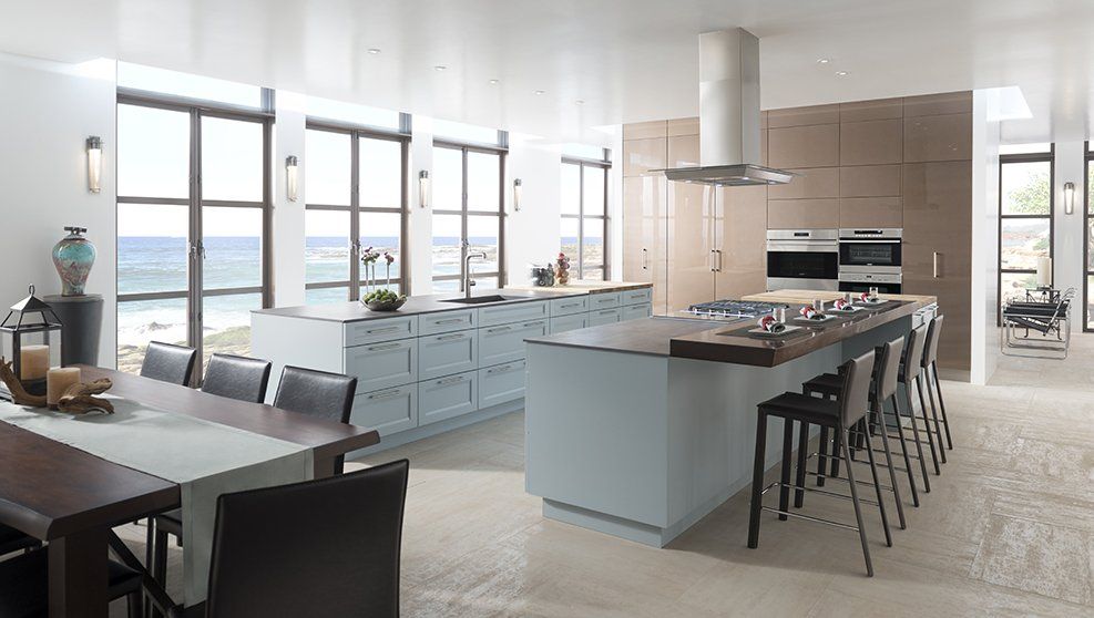 A kitchen with a large island and a dining table.
