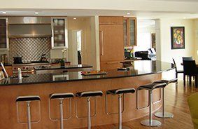 A kitchen with a large island and stools