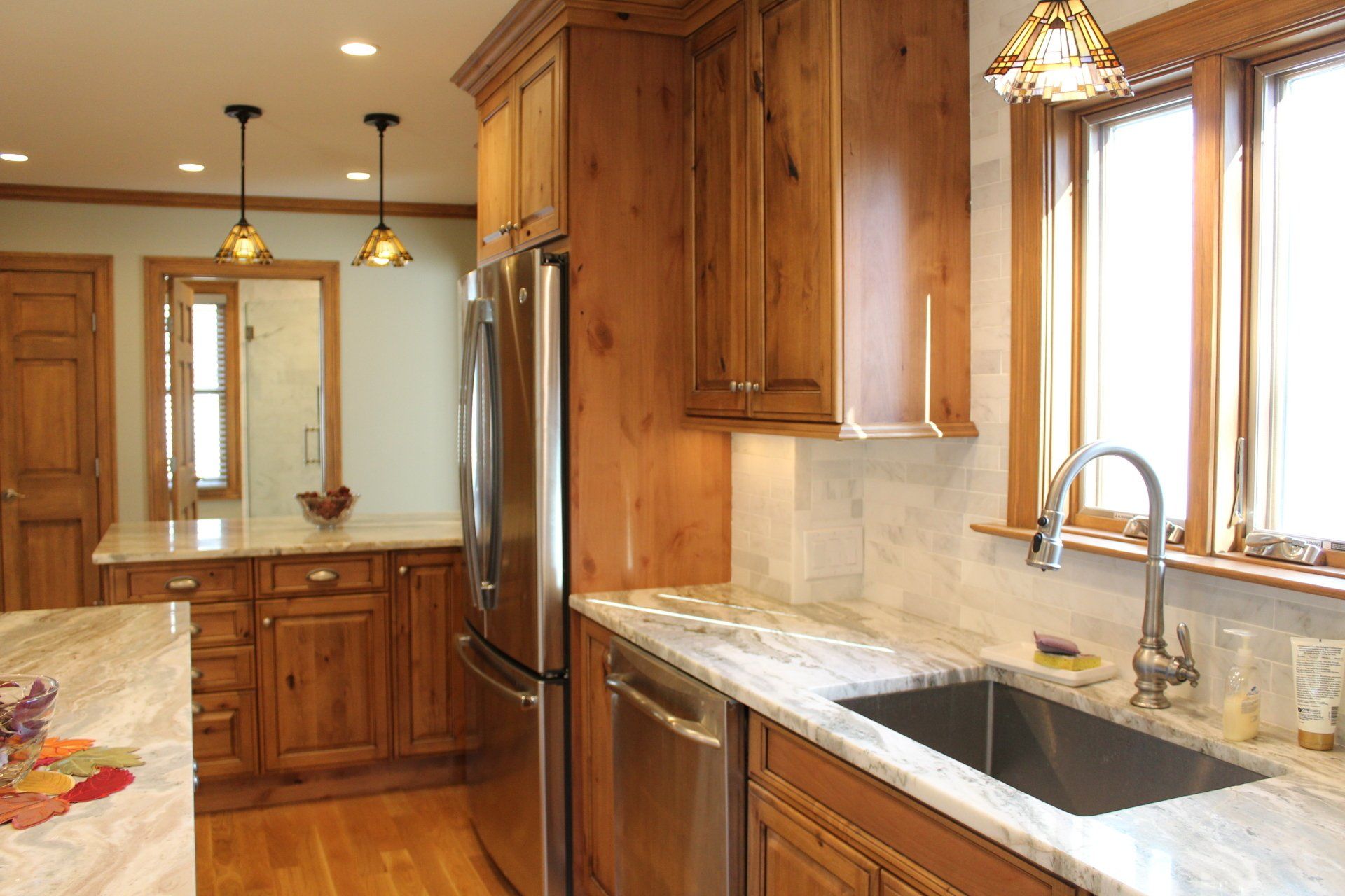 A kitchen with stainless steel appliances and wooden cabinets