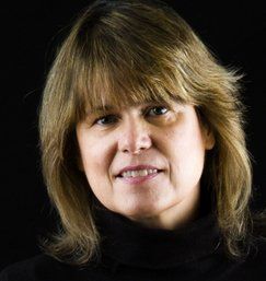 Sarah Doebler, LICSW, CSAT Member, New England Recovery Associates | Serving Duxbury, Greater Boston, South Shore to Cape Code, NE Rhode Island A person with shoulder-length blonde hair and bangs, smiling, against a plain black background.