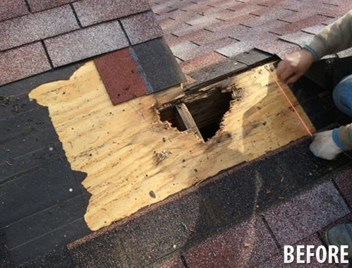A person is kneeling on a roof with a hole in it.