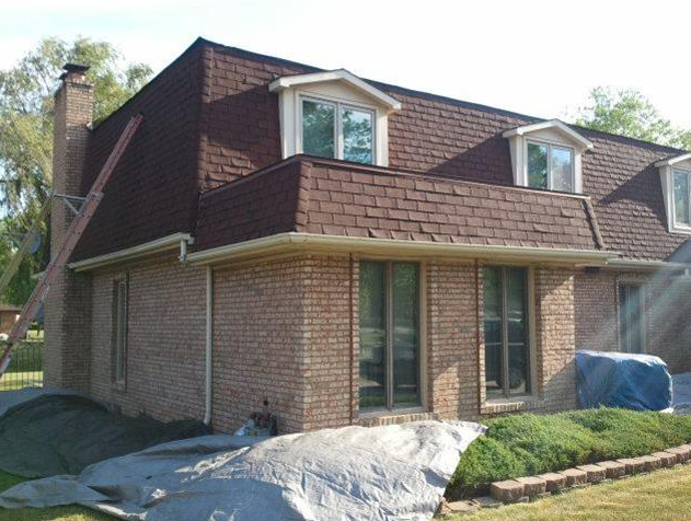 A large brick house with a red roof