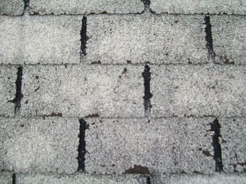 A close up of a roof with a lot of shingles on it.