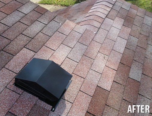 A roof with shingles and a black vent on it.