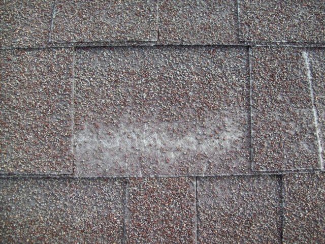 A close up of a roof with a lot of shingles on it.