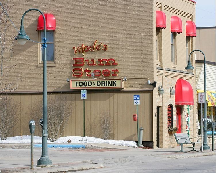 Street view of Wade’s Diner with red awnings and a “Food Drink” sign in winter.