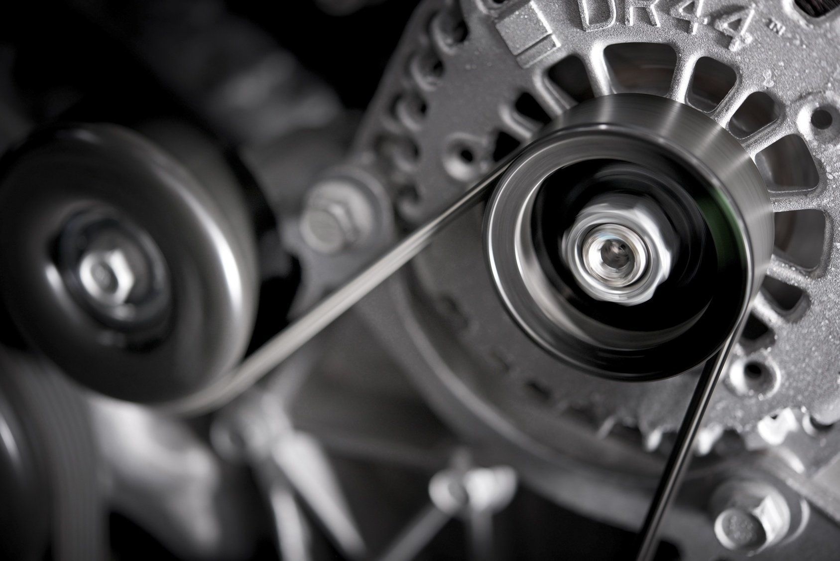 A close up of a belt on a car engine.