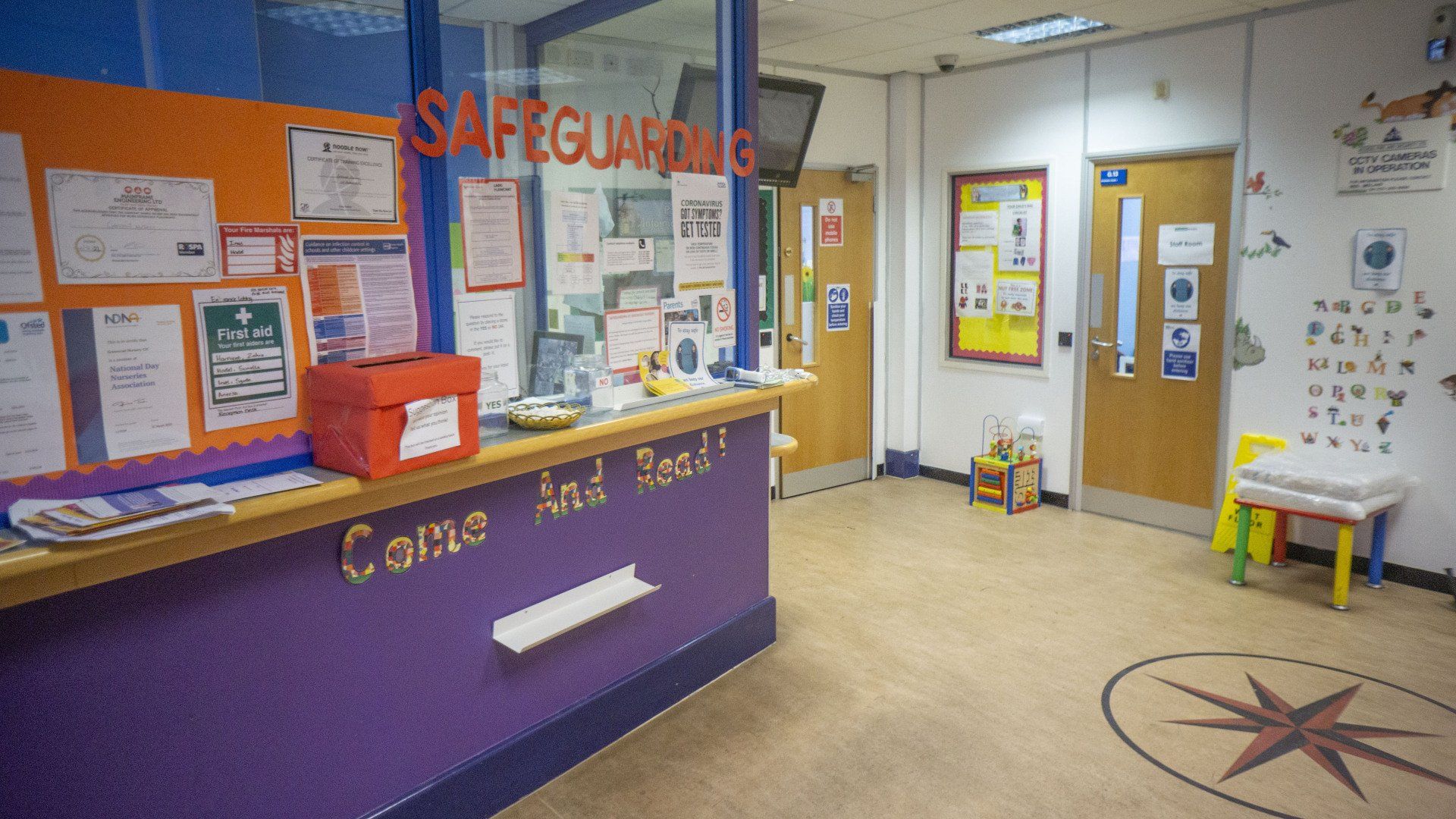 Reception area with a purple desk and 