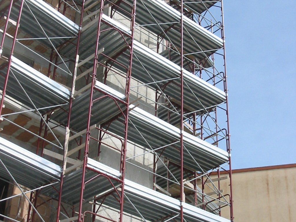 Un edificio in costruzione con impalcature sul lato