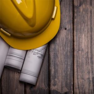 hard hat with blue print on wooden background